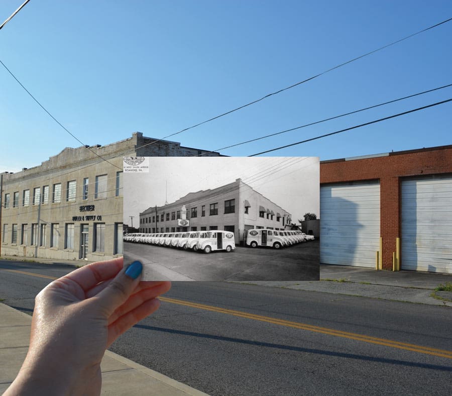 A hand holds a black-and-white photo of parked white buses over a modern street view.
