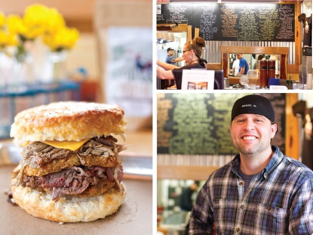 Brisket biscuit sandwich with cheese, beside a chalkboard menu and a smiling man in plaid.