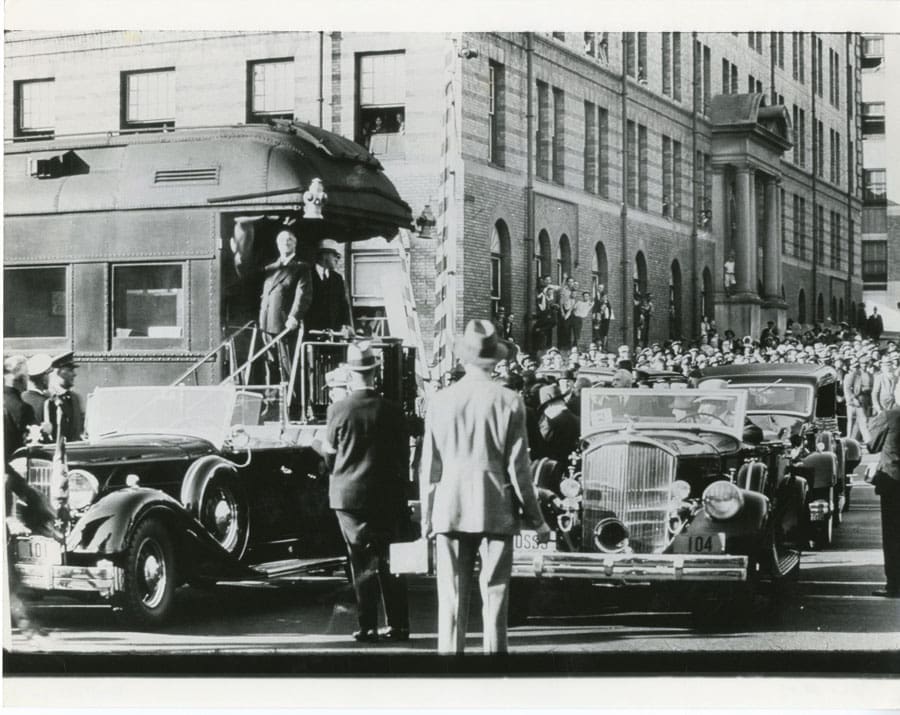 President Roosevelt greets the crowd in downtown Roanoke; N&W office building is in the background.