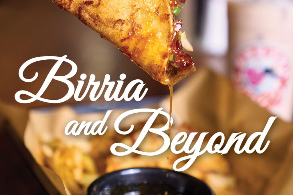 Signature birria tacos are served with a flavorful broth for dipping.