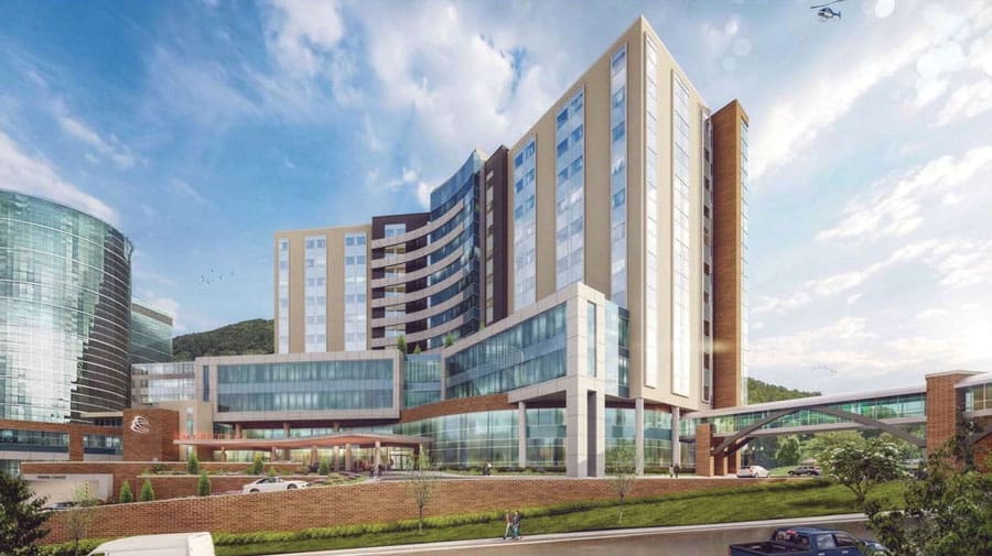 Architectural rendering of the Carilion Crystal Spring Tower, a tall glass and brick hospital building with a skywalk and a helicopter overhead.